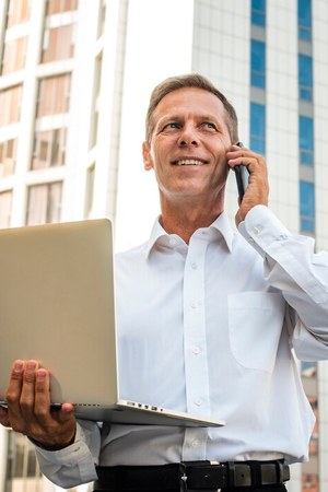 Property manager speaking on the phone at a laptop